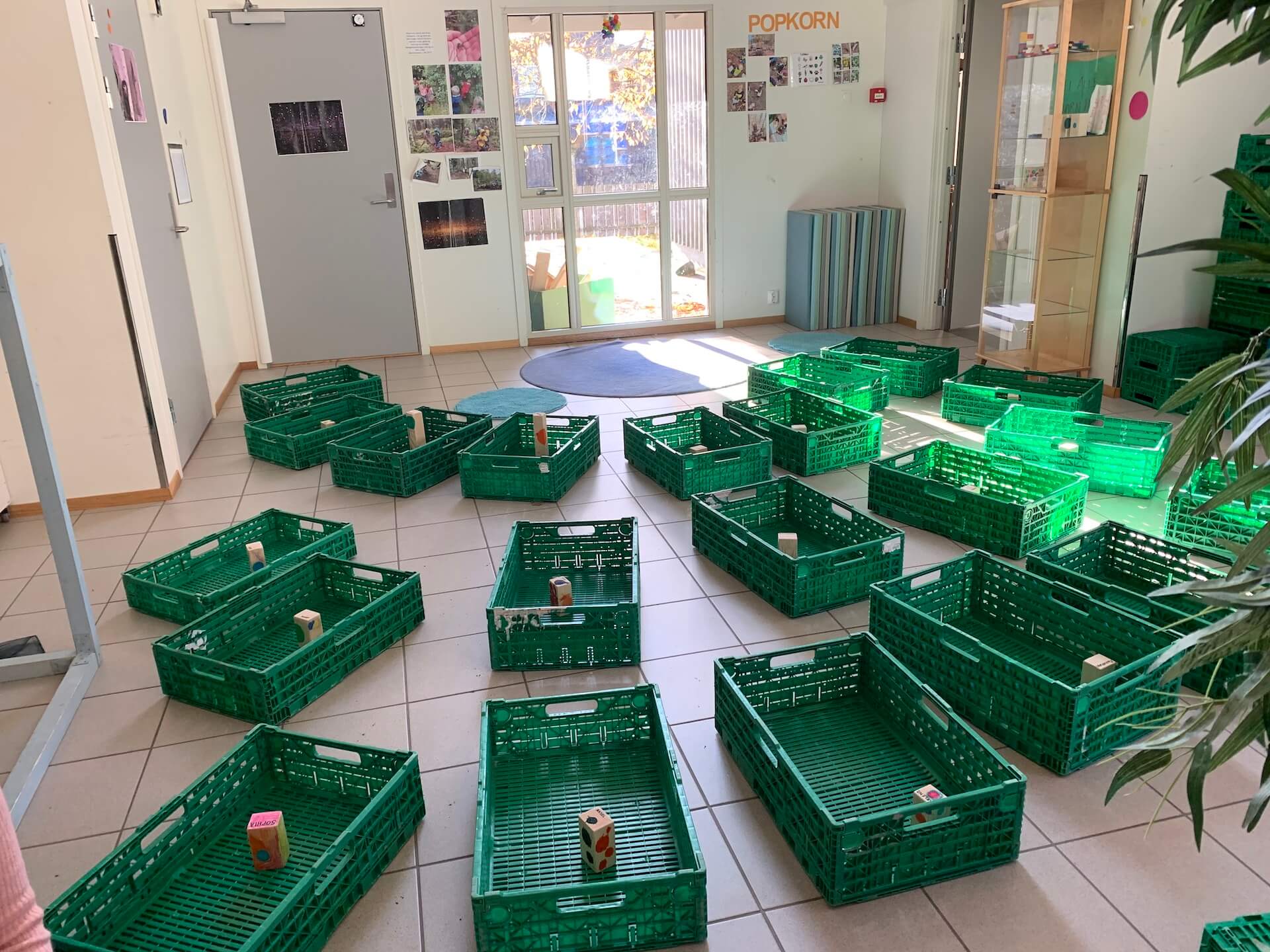 Photo of green bins. Each bin contains a block with painted dots on it.